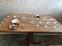 Photo showing all clear and ceramic bowls on wooden table with small, extra small, mid-size, and decorative bowls arranged.