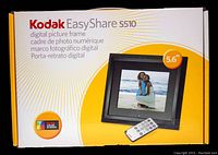 Box of Kodak EasyShare S510 digital picture frame showing front design, depicting the 5.6-inch display and remote control image.