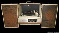 Front view of vintage 1960's Ambassador portable record player with detachable cloth-covered wooden speakers on each side.