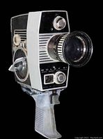 Front side of vintage Bolex Paillard S1 camera showing zoom lens and grip handle with trigger release.
