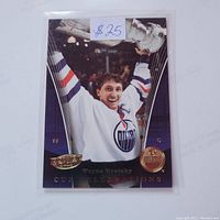 Front side of the Wayne Gretzky Edmonton Oilers Stanley Cup Champions hockey card featuring Gretzky holding the Stanley Cup.