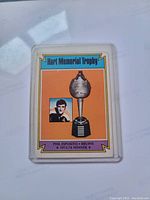 Front of 1975 Phil Esposito Hart Memorial Trophy hockey card showing trophy image and player photo