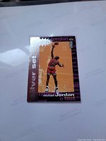 Front of the Michael Jordan Silver Set basketball card showing Jordan in red Bulls uniform dunking, with silver border and text.