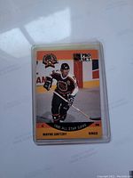 Front of 1990 Wayne Gretzky NHL All Star Game hockey card with player image and branding.