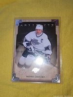 Front view of the Wayne Gretzky Artifacts hockey card showing the player in action wearing the Los Angeles Kings jersey and captain's C.