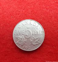 Reverse side of the coin with denomination FIVE 5 CENTS, maple leaves, and the year 1927 at the bottom.