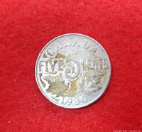Reverse of 1930 Canada 5 Cent Coin showing denomination and date with maple leaf design