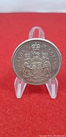 Obverse side showing Canadian coat of arms, year 1962, denomination 50 cents