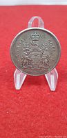 Reverse side of the 1965 Canada 50 cent silver coin displaying the Canadian coat of arms and inscriptions including the year and silver content.