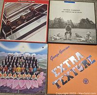 Four vinyl record album covers: The Beatles 1962-1966, George Harrison All Things Must Pass, The Beatles 65, George Harrison Extra Texture.