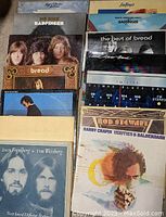 Photo of vinyl records arranged upright showing artist names and album covers from Loggins & Messina, Badfinger, Bread, Little River Band, Climax Blues Band, Boz Scaggs, Rod Stewart, Harry Chapin, Joannie Mitchell, Dan Fogelberg