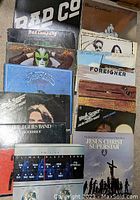 Photo of vinyl records collection with visible album cover art showing band names and album titles.