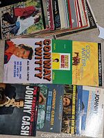 Photo showing a stack of vinyl records including visible titles by Johnny Cash, Conway Twitty, Cole Porter and Christmas albums