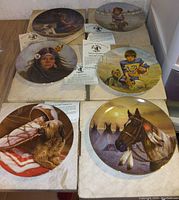 Six collector plates showing Native American and sports children themes with certificates of authenticity