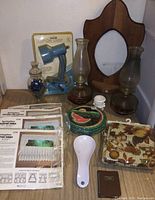 Overview of all items including lamps, basket, mirror, ceramic spoon rest, blue clamp lamp in packaging, and curtains packages.