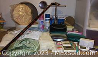 A wide view of the assortment on a tabletop showing the cane, sprays, hairdryer, and containers.