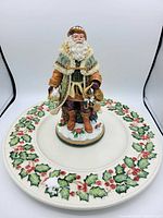 Photo of vintage Fitz and Floyd Christmas lot showing the Santa figurine on the holly serving plate.