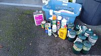 Overview photo of all items including chemicals and propane canisters with blue plastic basket