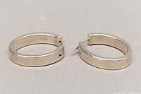 Pair of oval hoop earrings side by side showing overall shape