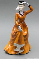 Front view of the porcelain figurine showing detailed features and dress color.