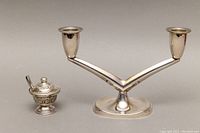 Photo of two items side by side showing the silver two-light candleholder and the covered salt cellar with tongs next to it.