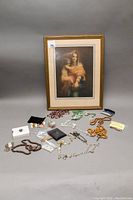 Full view of all religious items including framed print, rosary beads, crosses, and fridge magnets.