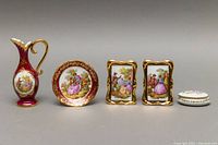 Full view of the five porcelain miniature items arranged in a row showing size and style differences.