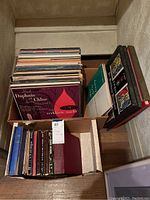 Photo showing approx 60 vintage vinyl records in various cardboard boxes, includes classical music covers visible.