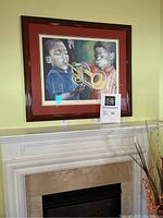 Full view of large framed print "Like Dis" above a white mantel on a greenish-yellow wall.