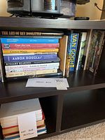 Books on shelf showing titles including The Art of Bev Doolittle, David C Driskell Art and Soul, Over the Line, Charles White, Aaron Douglas, Romare Bearden, Jacob Lawrence, Art of Elizabeth Catlett, Lin Emery.