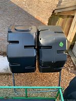 Front view of two black compost bins side by side on metal stand showing overall structure and size