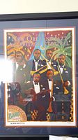 Framed 2005 New Orleans Jazz & Heritage Festival poster showing full artwork of jazz musicians in tuxedos with instruments and artist signature.