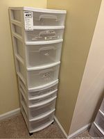 First image of the seven-drawer white plastic storage unit with labels on most drawers