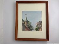 Full view of the framed watercolour painting showing the artwork of a church steeple and castle tower in a wooden frame.