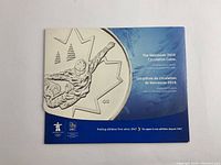 Cover photo of the blue display folder for Vancouver 2010 circulation coin set featuring an athlete design.
