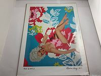 Full view of the fine art print featuring a reclining female figure on a colorful floral background, signed and numbered by the artist.
