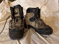 Front and side view of the La Sportiva hiking boots showing the brown suede and black toe cap, padded collar, and laces.