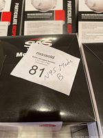 Six black SAS boxes of valved particulate respirator N95 masks, each marked as new and unopened. A tag on one box states '87 N95 Masks B'.