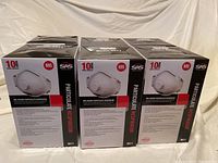 Photo of six unopened boxes of SAS Safety Corp N95 valved particulate respirator masks, each box labeled for 10 masks.
