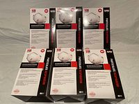 Six unopened boxes of SAS N95 valved particulate respirator masks arranged in two rows of three on a neutral surface.