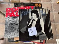 Stack of vinyl records showing Robert Palmer Clues, Rick Springfield Wait for Night, Isaac Hayes and others.