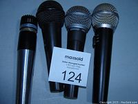 Four microphones displayed side by side from above, showing general size and shape.