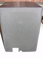 Front view of the JBL subwoofer showing black front grille and the JBL logo.