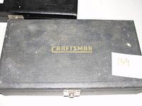 Closed black carrying case with gold Craftsman logo on top, showing exterior condition of case