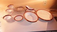Full set of 18 porcelain pieces arranged on countertop