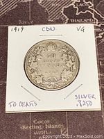 Image of the reverse side of the 1919 Canadian 50 cents coin showing denomination, year, and maple leaf wreath with crown.