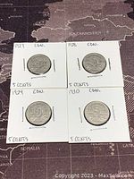 All four Canadian 5 cents coins from 1927, 1928, 1929, and 1930 in individual holders with year and denomination labeled.
