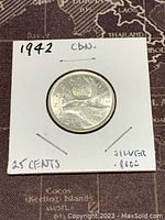 Reverse side depicting a caribou and date 1942, identifying the coin as Canadian 25 cents made of 80% silver.