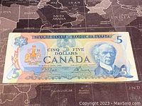 Front side of 1979 Canadian 5 dollar banknote showing portrait of Sir Wilfrid Laurier and denomination details.