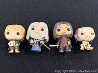 Group photo of all four Lord of the Rings Funko Pop! figures on black background